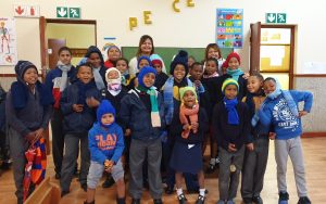 Starlights Creative Club - children receiving beanies and scarves